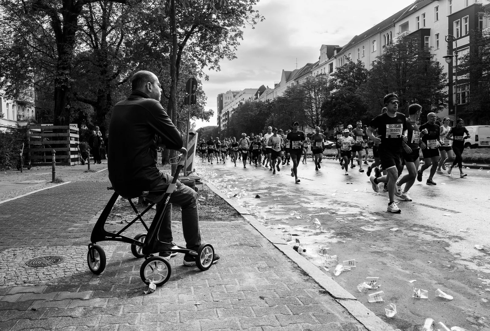 A person pushing a stroller down a lively street. Photograph by Adelina Persa.