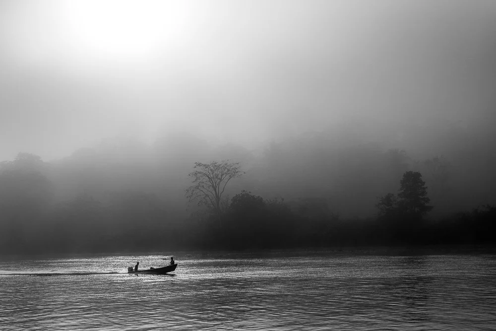 A boat on a misty lake. Photograph by Adelina Persa.